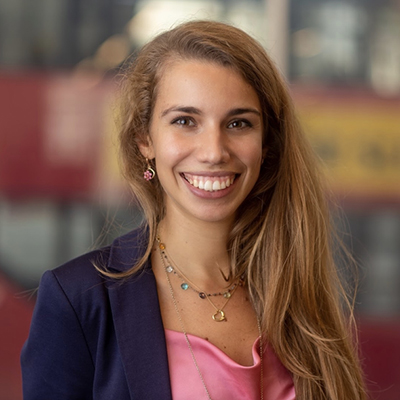 Profile pic of author Matillde Rosina, smiling in front of blurred background.